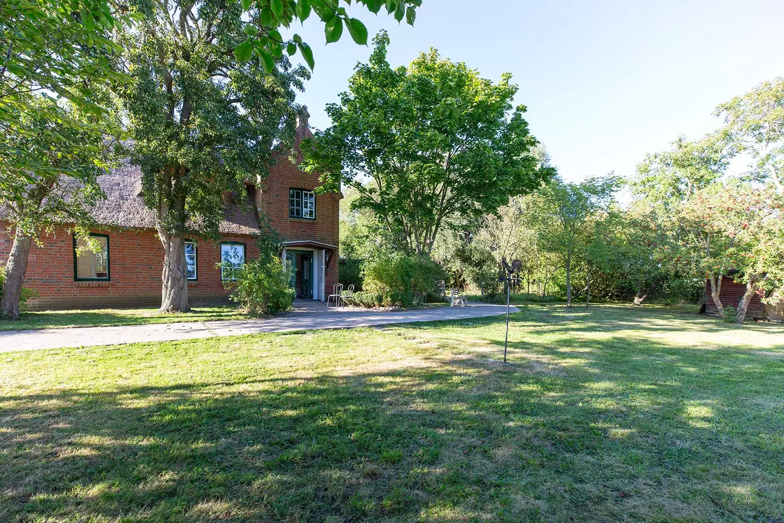 Garten des Deichschlösschens mit großem Wiesenanteil und Blick auf das Ferienhaus